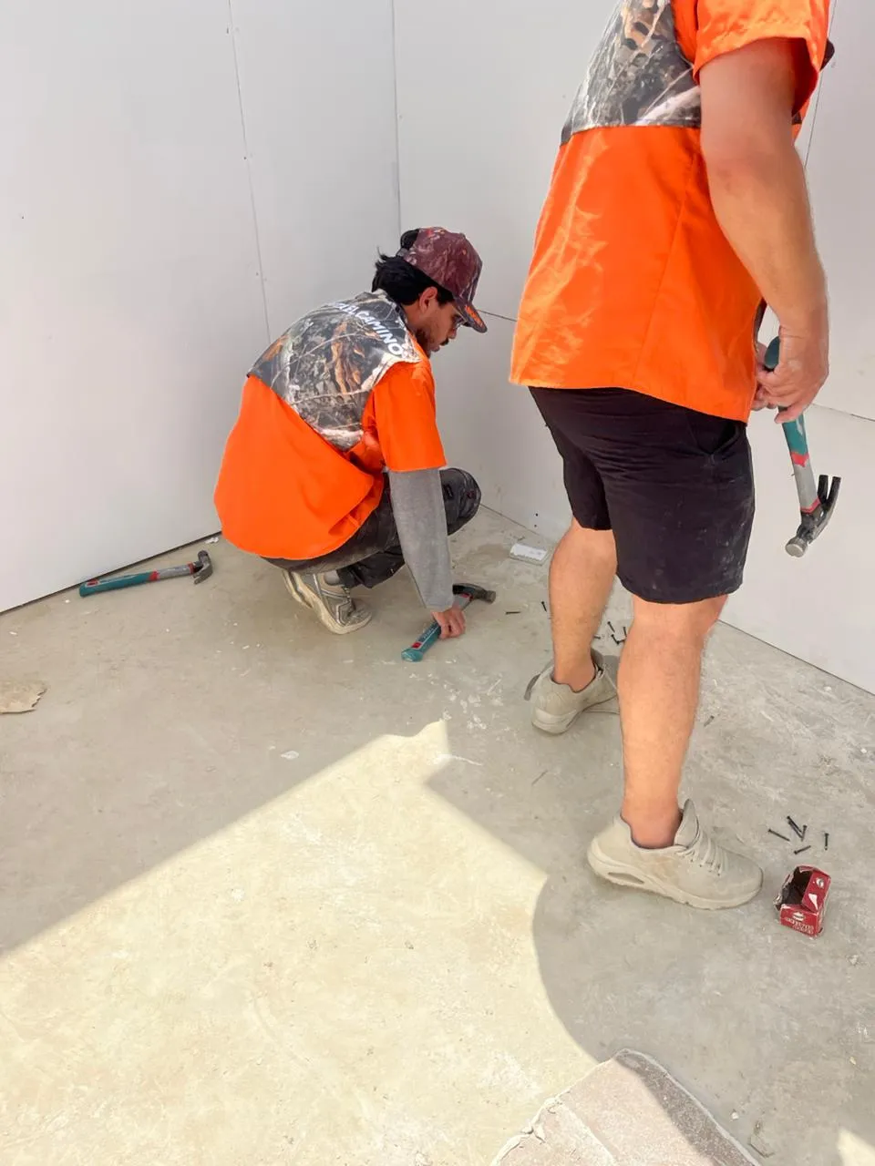 Volunteers in orange vests